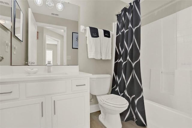 full bathroom featuring shower / bath combo, hardwood / wood-style flooring, vanity, and toilet