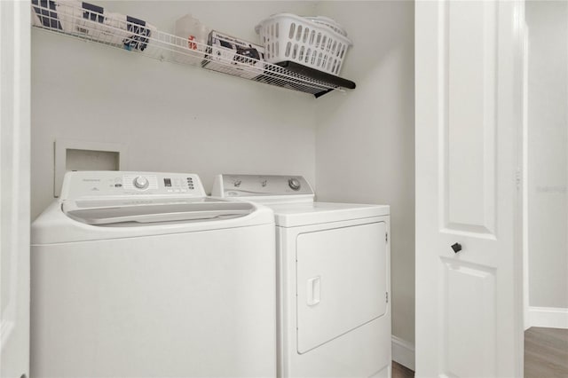 laundry room with light hardwood / wood-style floors and separate washer and dryer