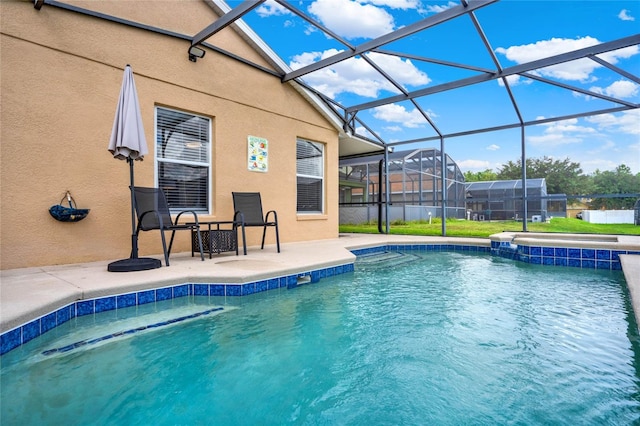 view of swimming pool featuring glass enclosure and a patio