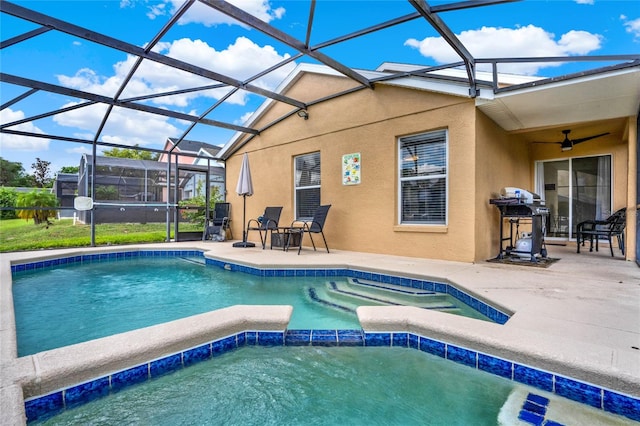 view of swimming pool featuring glass enclosure, an in ground hot tub, ceiling fan, and a patio area