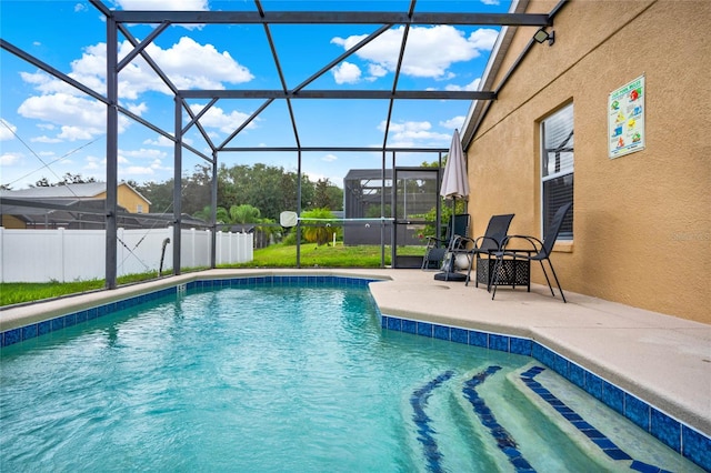 view of pool featuring glass enclosure and a patio area