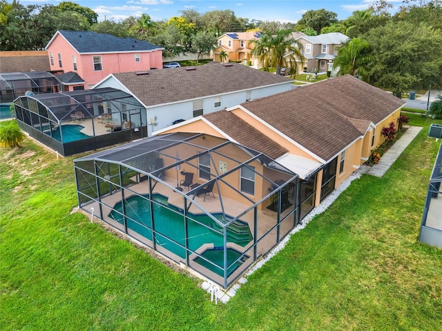 view of pool featuring a lanai, a patio area, and a yard