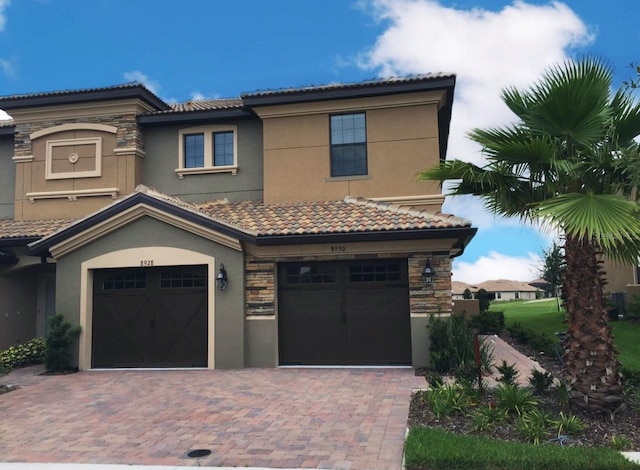 mediterranean / spanish-style house with a garage