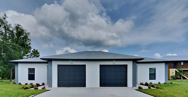 prairie-style home featuring a front yard and a garage