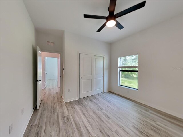 1320 Rio De Janeiro Ave, Punta Gorda, FL 33983 - unfurnished bedroom featuring light wood-style flooring, ceiling fan, and a closet