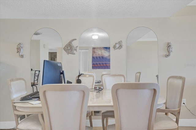 dining area featuring a textured ceiling