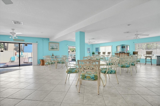 unfurnished dining area featuring light tile patterned flooring and a textured ceiling