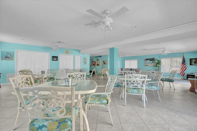 dining space with ceiling fan and light tile patterned floors