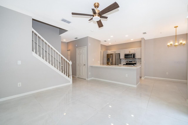 interior space featuring ceiling fan with notable chandelier and light tile patterned floors