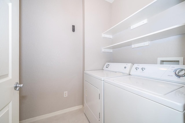 laundry room featuring light tile patterned floors and independent washer and dryer