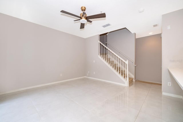 unfurnished room with ceiling fan and light tile patterned flooring