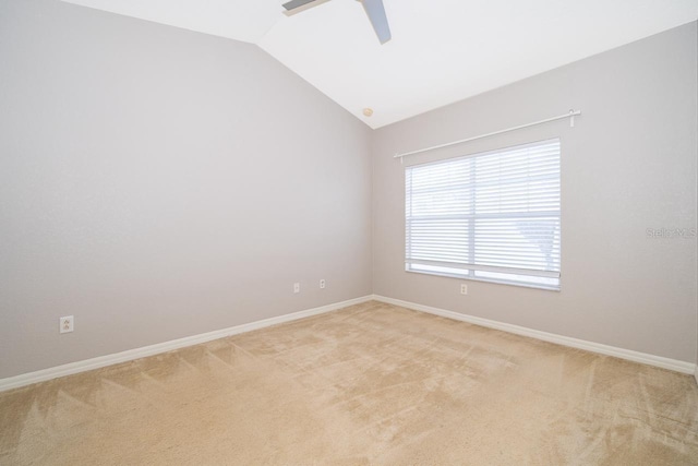 carpeted spare room with vaulted ceiling and ceiling fan