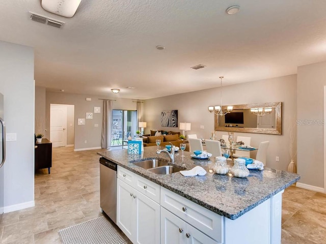 kitchen featuring dishwasher, sink, a center island with sink, and white cabinets