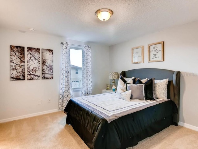 carpeted bedroom featuring a textured ceiling