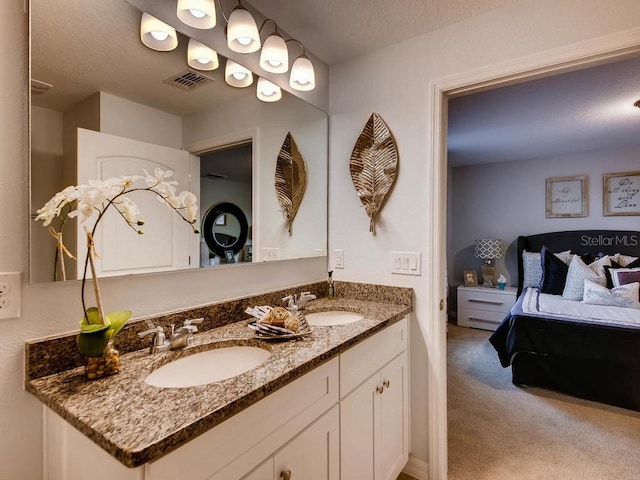 bathroom with vanity and a textured ceiling