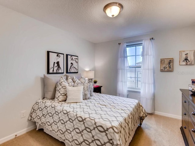 carpeted bedroom featuring a textured ceiling