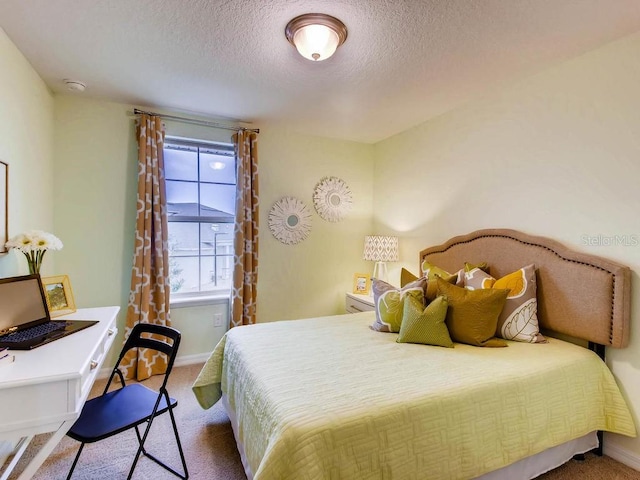 bedroom featuring carpet flooring and a textured ceiling