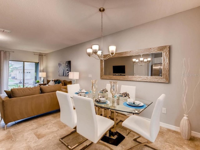 dining area featuring a chandelier