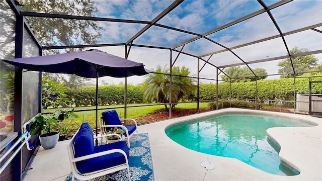 view of swimming pool featuring glass enclosure and a patio