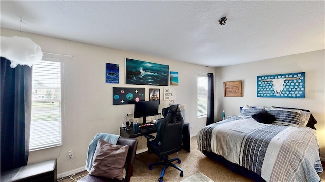 bedroom featuring carpet floors and a textured ceiling