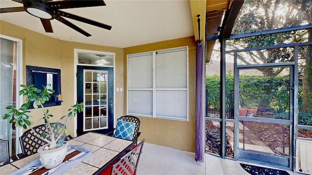 sunroom / solarium featuring ceiling fan