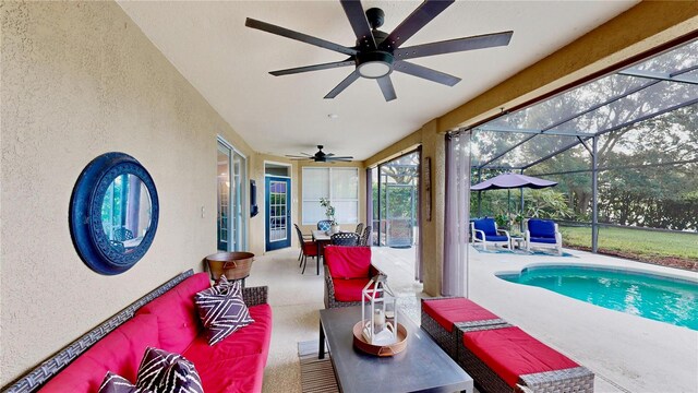 sunroom featuring ceiling fan