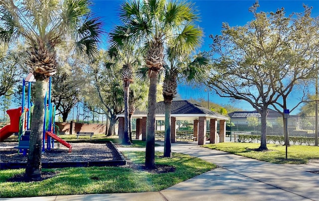 view of community featuring a playground, a gazebo, and a yard