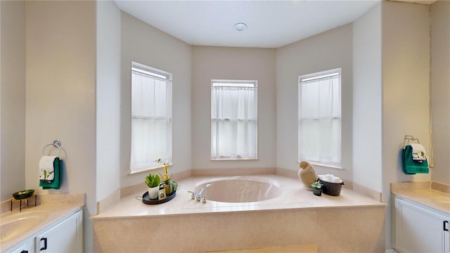 bathroom featuring a bath, a wealth of natural light, and vanity