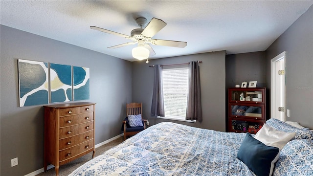 carpeted bedroom with a textured ceiling and ceiling fan