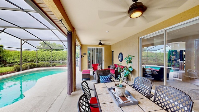 view of pool featuring ceiling fan, a lanai, and a patio area