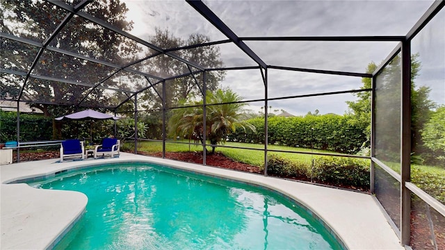 view of swimming pool featuring glass enclosure and a patio