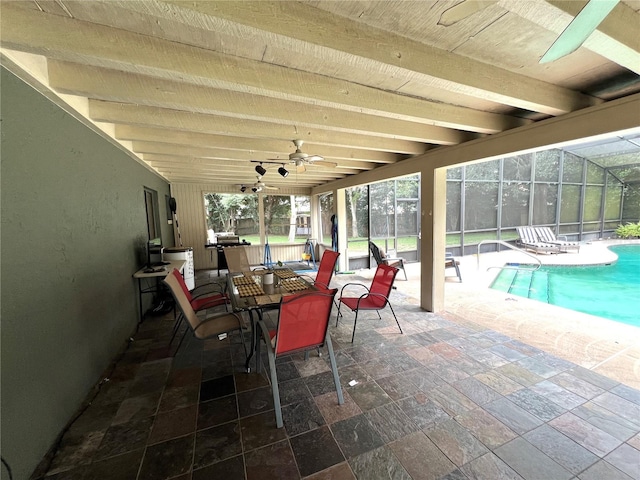 view of patio featuring a lanai, an indoor pool, and ceiling fan