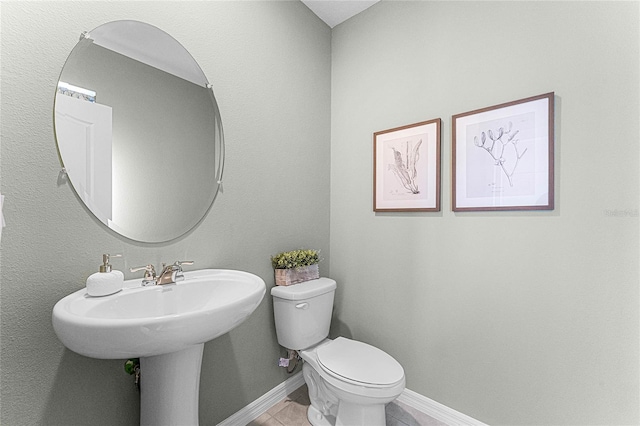 bathroom featuring toilet and tile patterned floors