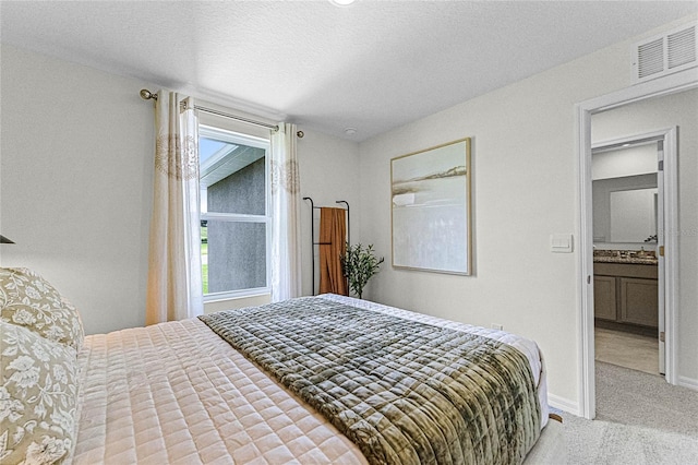 carpeted bedroom featuring a textured ceiling