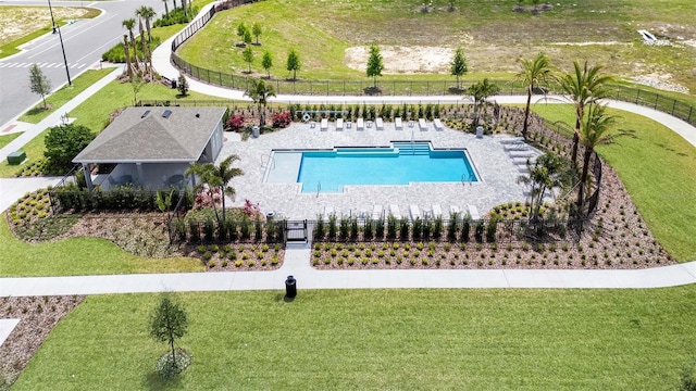 view of swimming pool featuring a patio and a lawn