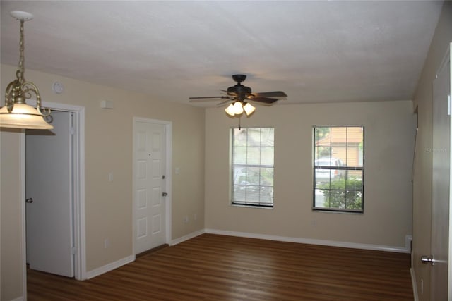 spare room featuring dark hardwood / wood-style flooring and ceiling fan