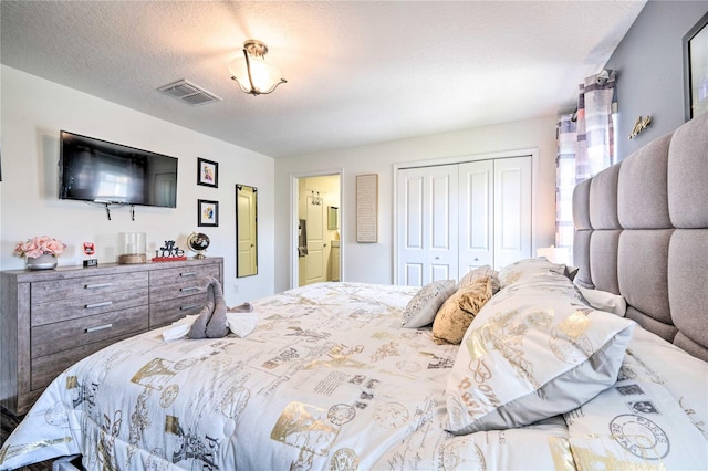 bedroom with a textured ceiling and a closet