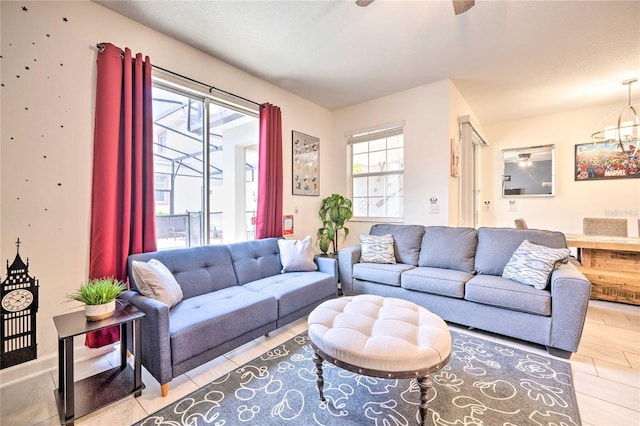 living room featuring a textured ceiling and an inviting chandelier