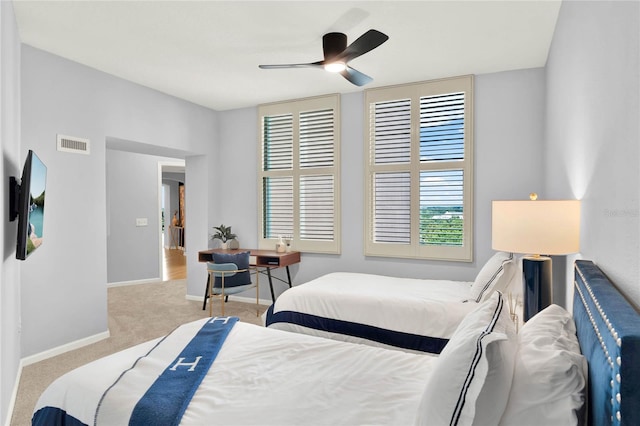 carpeted bedroom featuring baseboards, ceiling fan, and visible vents
