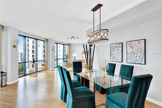 dining space with light hardwood / wood-style flooring and a chandelier