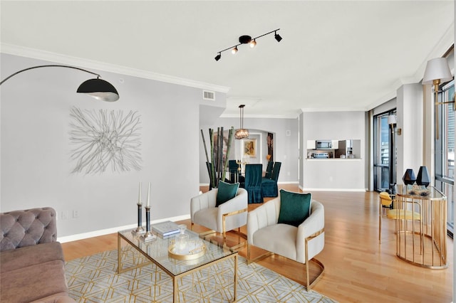 living room with ornamental molding and hardwood / wood-style flooring