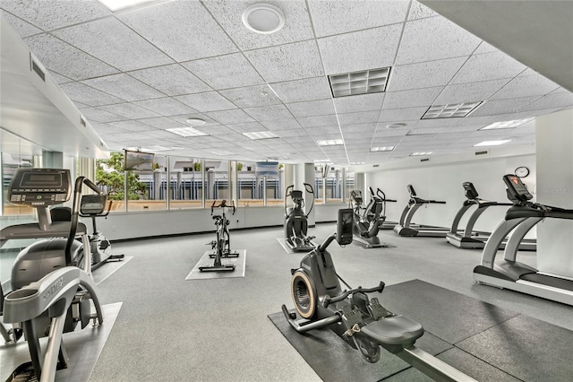 gym featuring visible vents and a paneled ceiling