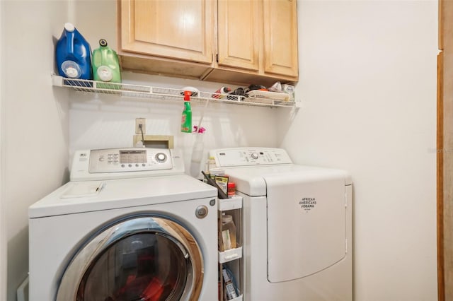 laundry room featuring cabinets and separate washer and dryer