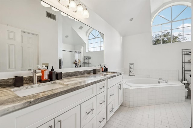 bathroom with vanity, tile patterned floors, separate shower and tub, and vaulted ceiling