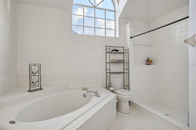 bathroom featuring toilet, shower with separate bathtub, and tile patterned flooring