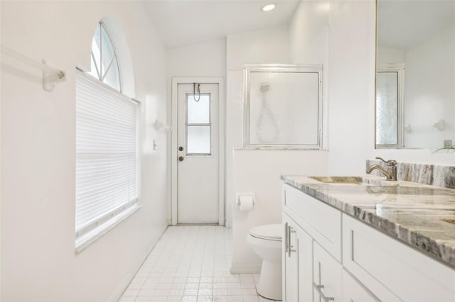 bathroom featuring lofted ceiling, toilet, tile patterned flooring, vanity, and walk in shower