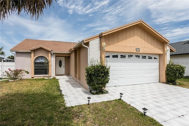 ranch-style home with a garage and a front lawn