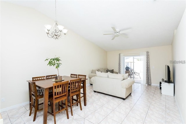 tiled dining room with vaulted ceiling and ceiling fan with notable chandelier