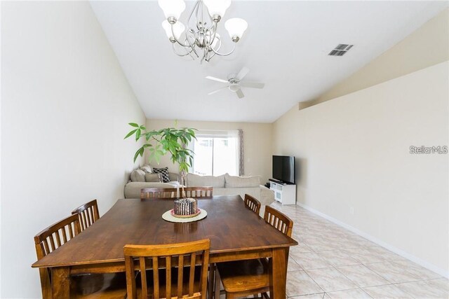 tiled dining area featuring ceiling fan with notable chandelier and lofted ceiling