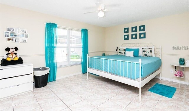 bedroom with ceiling fan and light tile patterned floors